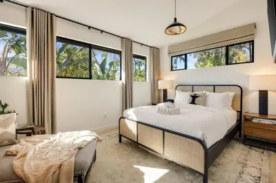 a bedroom with a bed and some windows at Hollywood Hills Villa by Universal - Pool - Dogs OK in Los Angeles