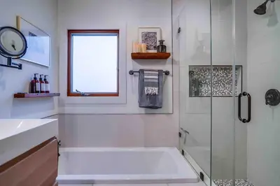 a white bathroom with a shower and a sink at Projector - Pool Table - 15min DT - Pets OK - BBQ in Los Angeles