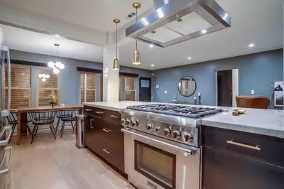 a kitchen with a stove and a dining room at Projector - Pool Table - 15min DT - Pets OK - BBQ in Los Angeles