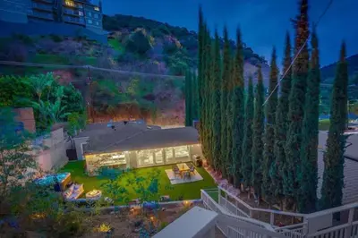 a house with a large yard with a building at Hollywood Hills Retreat - Private GYM & STEAM ROOM in Los Angeles
