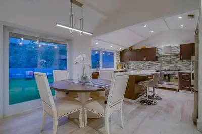 a kitchen and dining room with a table and chairs at Hollywood Hills Retreat - Private GYM & STEAM ROOM in Los Angeles