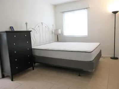a bedroom with a bed and a dresser and a window at 4902 Sandyland Road #247 in Carpinteria