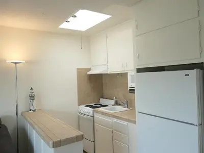 a white kitchen with a sink and a refrigerator at 4902 Sandyland Road #247 in Carpinteria