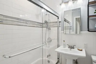 a white bathroom with a shower and a sink at 4980 Sandyland Road #215 in Carpinteria