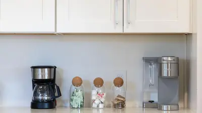 a kitchen counter with a coffeemaker and a coffee maker at Designer Retreat w Pool Firepits Panoramic Views The Lake House at Malibu in Agoura Hills