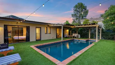 a backyard with a swimming pool and a house at Designer Retreat w Pool Firepits Panoramic Views The Lake House at Malibu in Agoura Hills