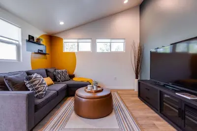 a living room with a couch and a flat screen tv at New and Modern Casita VIP in San Dimas