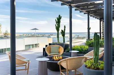 a patio with chairs and a fire pit with a view of the beach at The Diamond Dune Three floors Two Balconies BBQ in Los Angeles