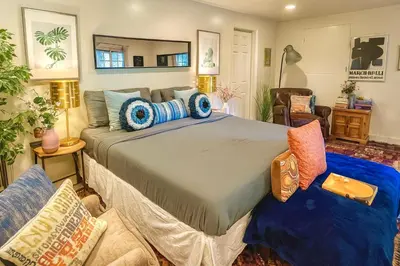 a bedroom with a large bed in a room at Hollywood Hills Spa Retreat Oasis with Tree Top Views, Private Jacuzzi Style Tub, Steam Room, Magical Half Acre Acre Garden and Patio, Free Parking for 2 cars, in LA's most Serene, Central Desirable Area in Los Angeles