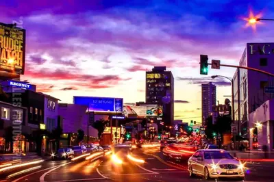 a busy city street with cars stopped at a traffic light at Hollywood Hills Spa Retreat Oasis with Tree Top Views, Private Jacuzzi Style Tub, Steam Room, Magical Half Acre Acre Garden and Patio, Free Parking for 2 cars, in LA's most Serene, Central Desirable Area in Los Angeles