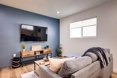 a living room with a couch and a flat screen tv at NEW and Modern Cozy Flat in Southern California in Covina