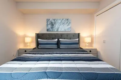 a bedroom with a blue and white bed with two lamps at Cozy 2BR Apt in Downtown LA with Pool & Hot Tub in Los Angeles