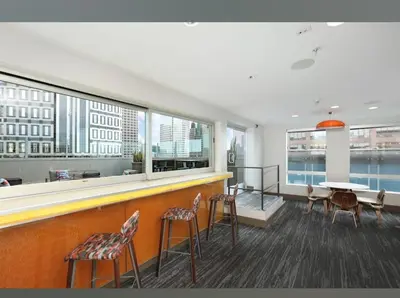 a restaurant with a bar with chairs and a table at Cozy 2BR Apt in Downtown LA with Pool & Hot Tub in Los Angeles