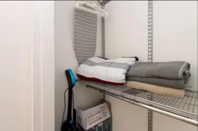a shelf with towels on it in a room at Walk to Santa Monica Beach Pier Boardwalk Venice in Los Angeles