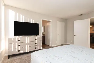 a bedroom with a flat screen tv on a dresser at 2BR Hollywood Apt with Rooftop Pool & Stunning Views in Los Angeles