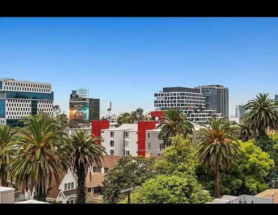 a city skyline with palm trees and buildings at Modern Escape in Hollywood with Rooftop & City Views in Los Angeles