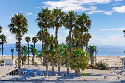 a view of a beach with palm trees and the ocean at The Amethyst Retreat Ocean Marina Panoramic View in Los Angeles