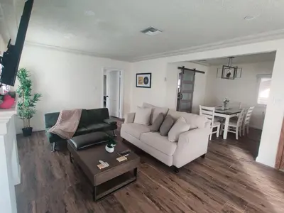 a living room with a couch and a table at sofi intuit cozy home free parking queen beds in Inglewood
