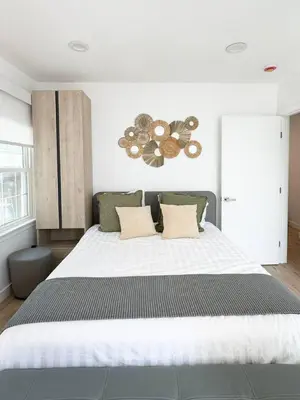 a bedroom with a large bed with a large white bedspread at Bright and Chic 3BR-3BA by Century City - FH-BV in Los Angeles