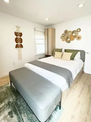 a bedroom with a large bed with a bench in it at Bright and Chic 3BR-3BA by Century City - FH-BV in Los Angeles