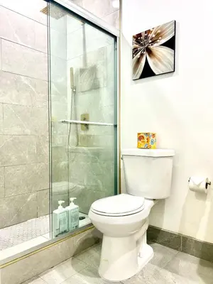 a bathroom with a toilet and a glass shower at LA Modern Street View Glass Window 2BR in North Sherman Way