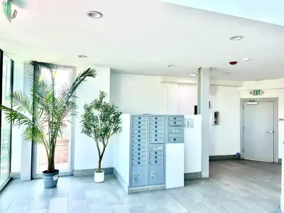 an office lobby with plants and a filing cabinet at LA Modern Street View Glass Window 2BR in North Sherman Way