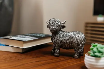 a statue of a bull on a table with a book at Stunning 2 bedroom near by The Grove in Los Angeles
