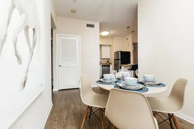 a dining room with a white table and chairs at Stunning 2 bedroom near by The Grove in Los Angeles