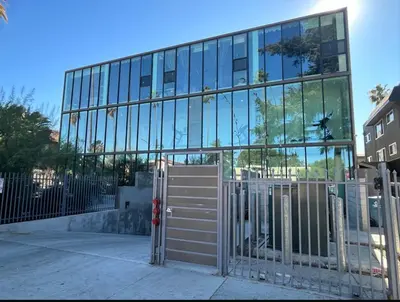 a glass building with a gate in front of it at Modern New Studio Cozy&Prime Location in North Sherman Way