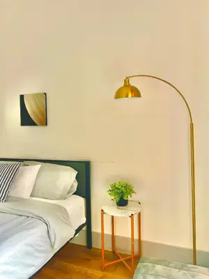 a bedroom with a bed and a table with a lamp at Modern New Studio Cozy&Prime Location in North Sherman Way
