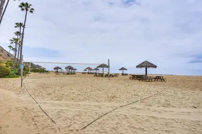 a beach with picnic tables and umbrellas on it at Walk to Private Beach Rancho Palos Verdes Escape! in Rancho Palos Verdes