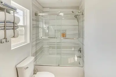 a bathroom with a glass shower with a toilet at 4 Mi to SoFi Stadium Pet-Friendly LA Area Home in Los Angeles