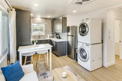 a kitchen and living room with a washer and dryer at 4 Mi to SoFi Stadium Pet-Friendly LA Area Home in Los Angeles