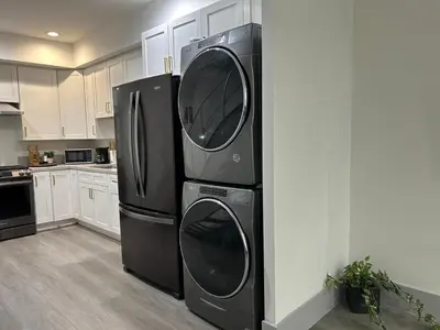 two washer and dryer stacked on top of each other in a kitchen at Newly Built Modern Central 2B On Sherman with Free Parking in North Sherman Way