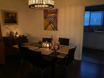 a dining room table with chairs and a chandelier at Spanish Cottage on Rosewood Avenue, Los Angeles , Melrose Village in Los Angeles