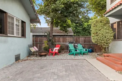 a patio with colorful chairs and a fence at Bright Coastal Escape 4 Bedroom 2 Bath Near CSULB Long Beach Airport and Beach in Long Beach