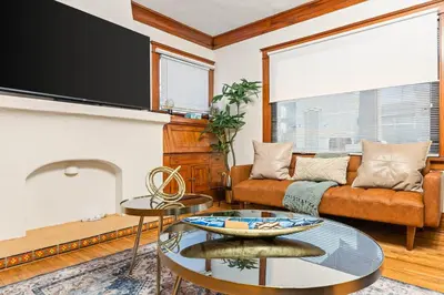 a living room with a couch and a tv at Bright Coastal Escape 4 Bedroom 2 Bath Near CSULB Long Beach Airport and Beach in Long Beach