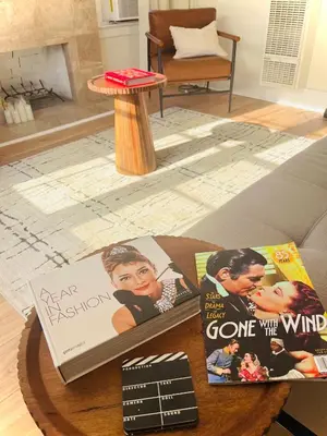 a coffee table with some books and a sign on it at Honeywood in Hollywood! in Los Angeles