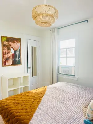 a bedroom with a bed and a poster of a couple at Honeywood in Hollywood! in Los Angeles