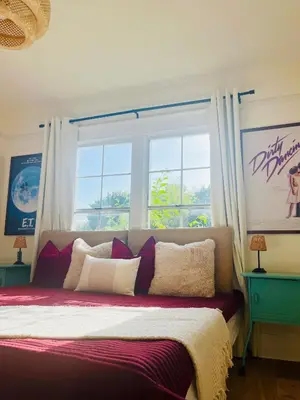 a bedroom with a large bed with a window at Honeywood in Hollywood! in Los Angeles