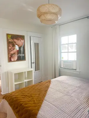 a bedroom with a bed and a poster on the wall at Honeywood in Hollywood! in Los Angeles