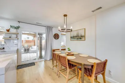 a dining room and living room with a table and chairs at Walk to Big Bear Marina Modern Home with Hot Tub! in Big Bear Lake