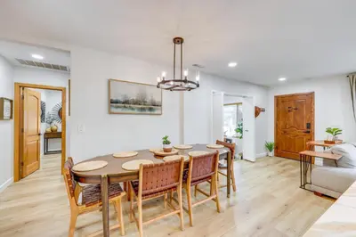 a dining room and living room with a table and chairs at Walk to Big Bear Marina Modern Home with Hot Tub! in Big Bear Lake