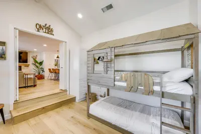 a bedroom with a bunk bed and a hallway at Walk to Big Bear Marina Modern Home with Hot Tub! in Big Bear Lake