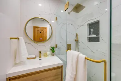 a bathroom with a sink and a mirror at Walk to Big Bear Marina Modern Home with Hot Tub! in Big Bear Lake