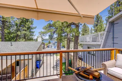 a balcony with a couch and a chair at Walk to The Village ShopsandEats Big Bear Lake Home in Big Bear Lake