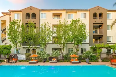 an apartment building with a pool in front of it at Premier Suites at Marina-Venice with Luxe Pool, Gym & Hot Tub & More in Los Angeles