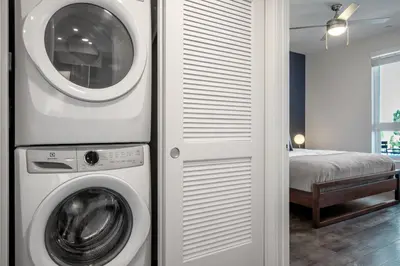 a washer and dryer in a room with a bed at Culver City 1BR w Pool Gym WD nr Downtown LAX-173 in Los Angeles