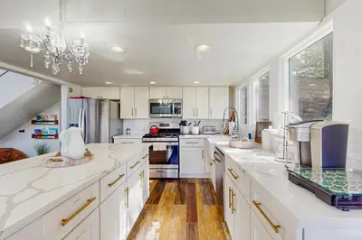 a kitchen with white cabinets and white counter tops at Cielo Ridge in Twin Peaks