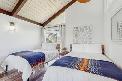 two beds in a room with a window at Cielo Ridge in Twin Peaks